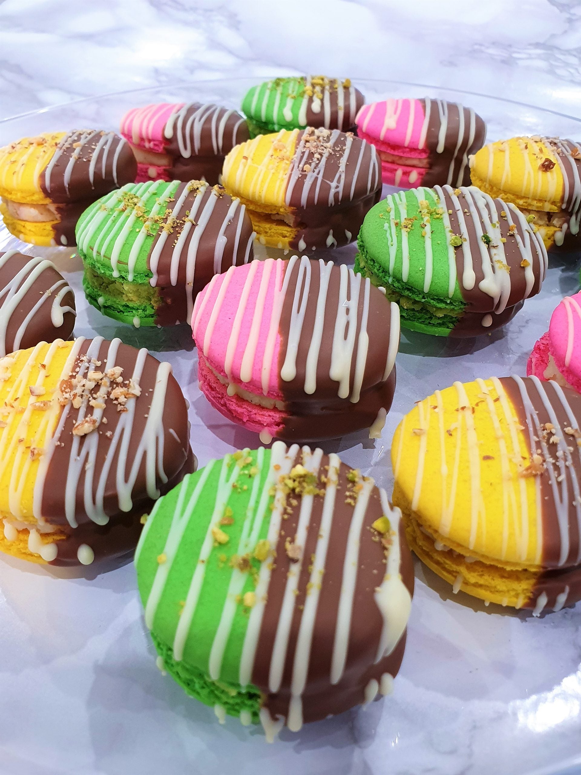 10 Chocolate Dipped Barfi Filled Macarons.